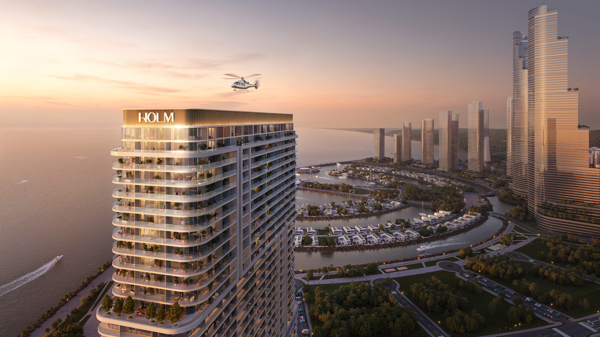 La tour One Peninsula au coucher du soleil à Ambassadori Island ONE PENINSULA Batumi by HOLM Developments — illuminated HOLM tower at sunset seen from a helicopter above Ambassadori Island